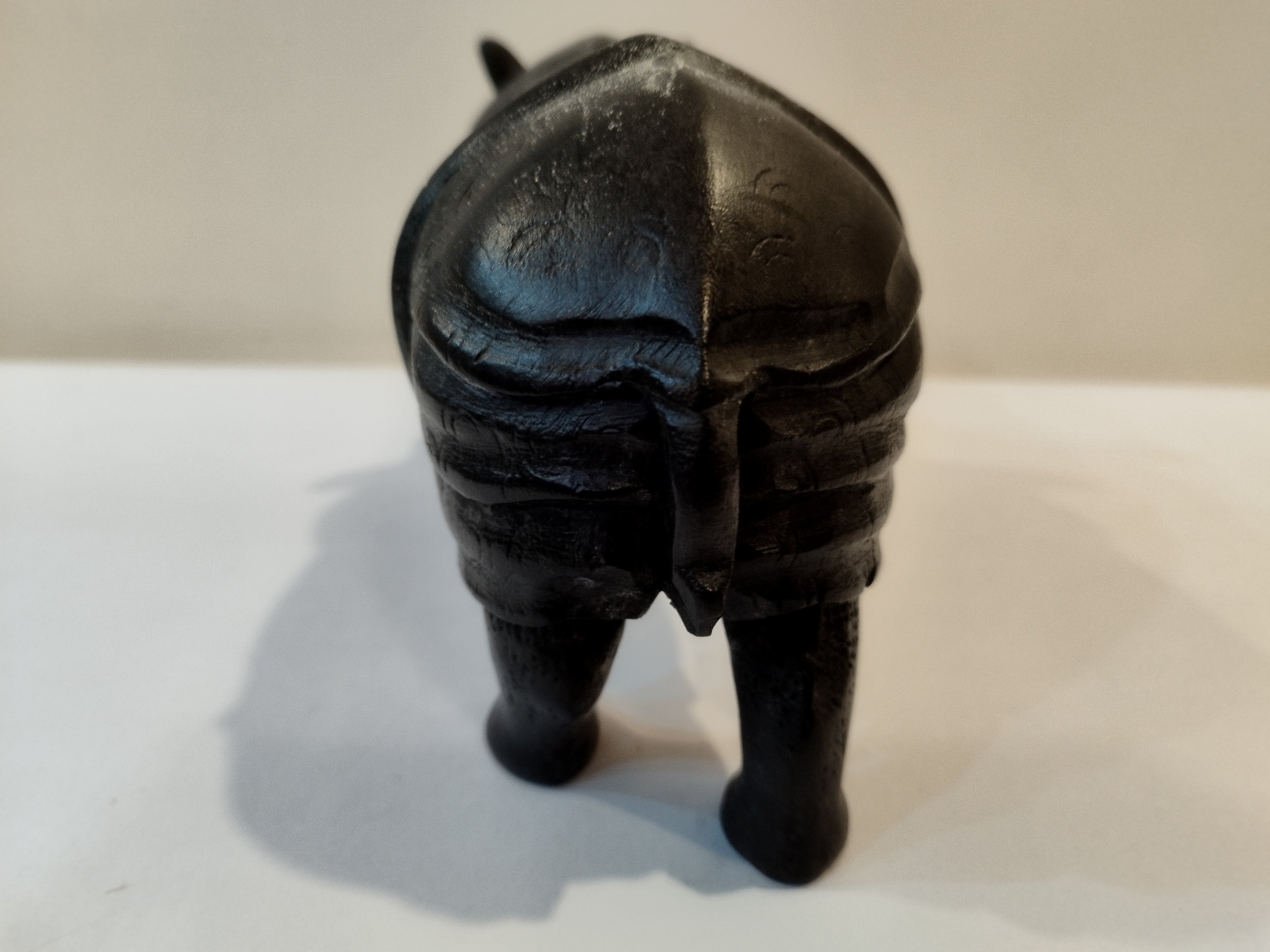 Rhino in black wood, five inches height and nine inch in length. Well known to give strength to a person, family, office.