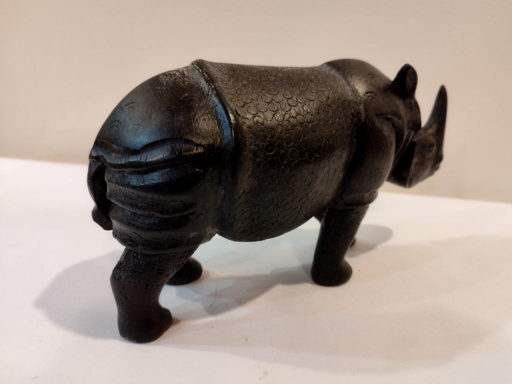 Rhino in black wood, five inches height and nine inch in length. Well known to give strength to a person, family, office.