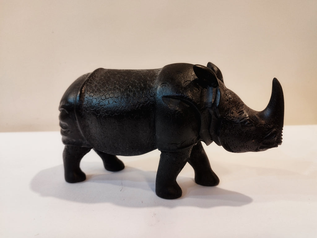 Rhino in black wood, five inches height and nine inch in length. Well known to give strength to a person, family, office.