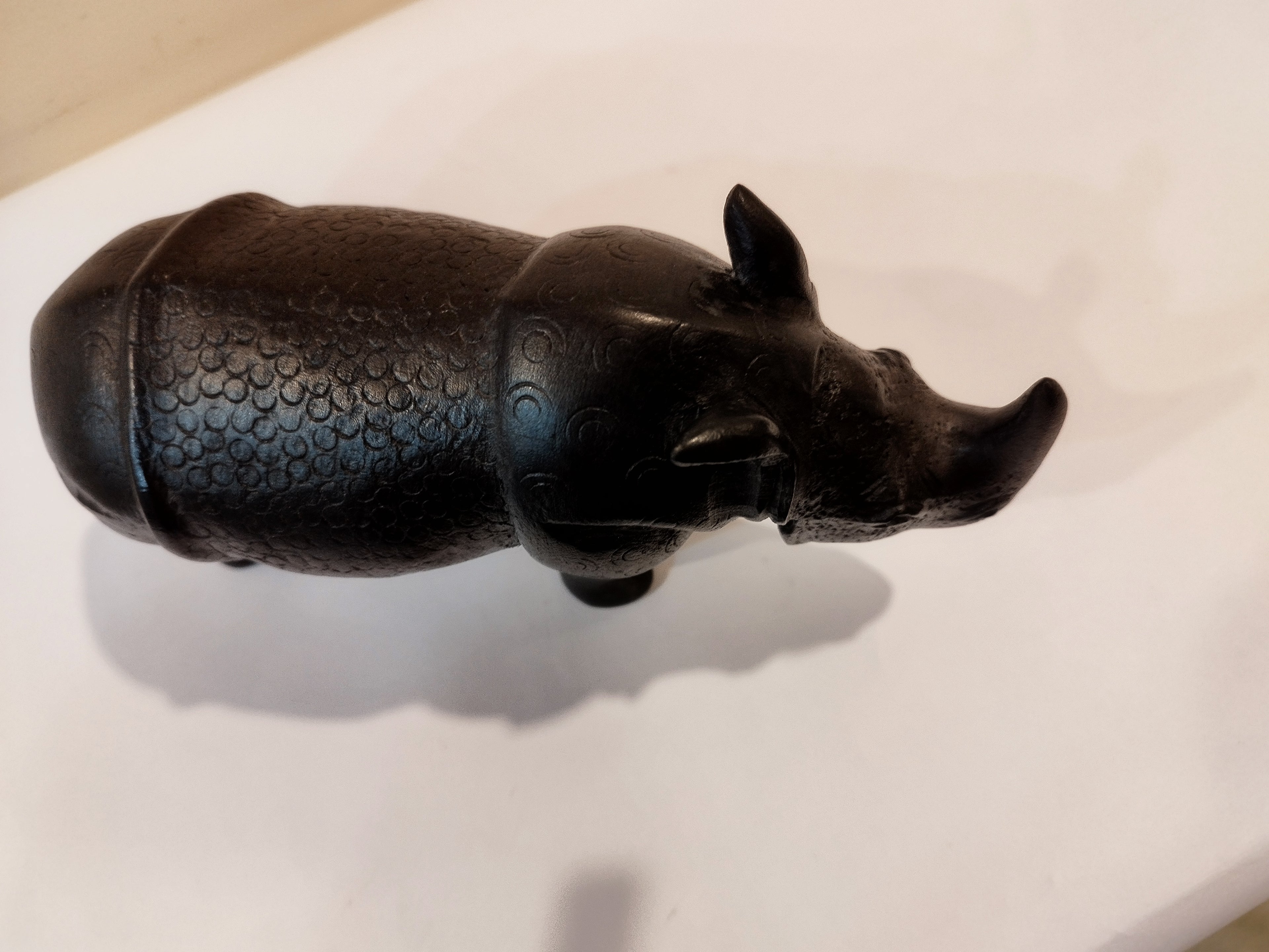 Rhino in black wood, five inches height and nine inch in length. Well known to give strength to a person, family, office.