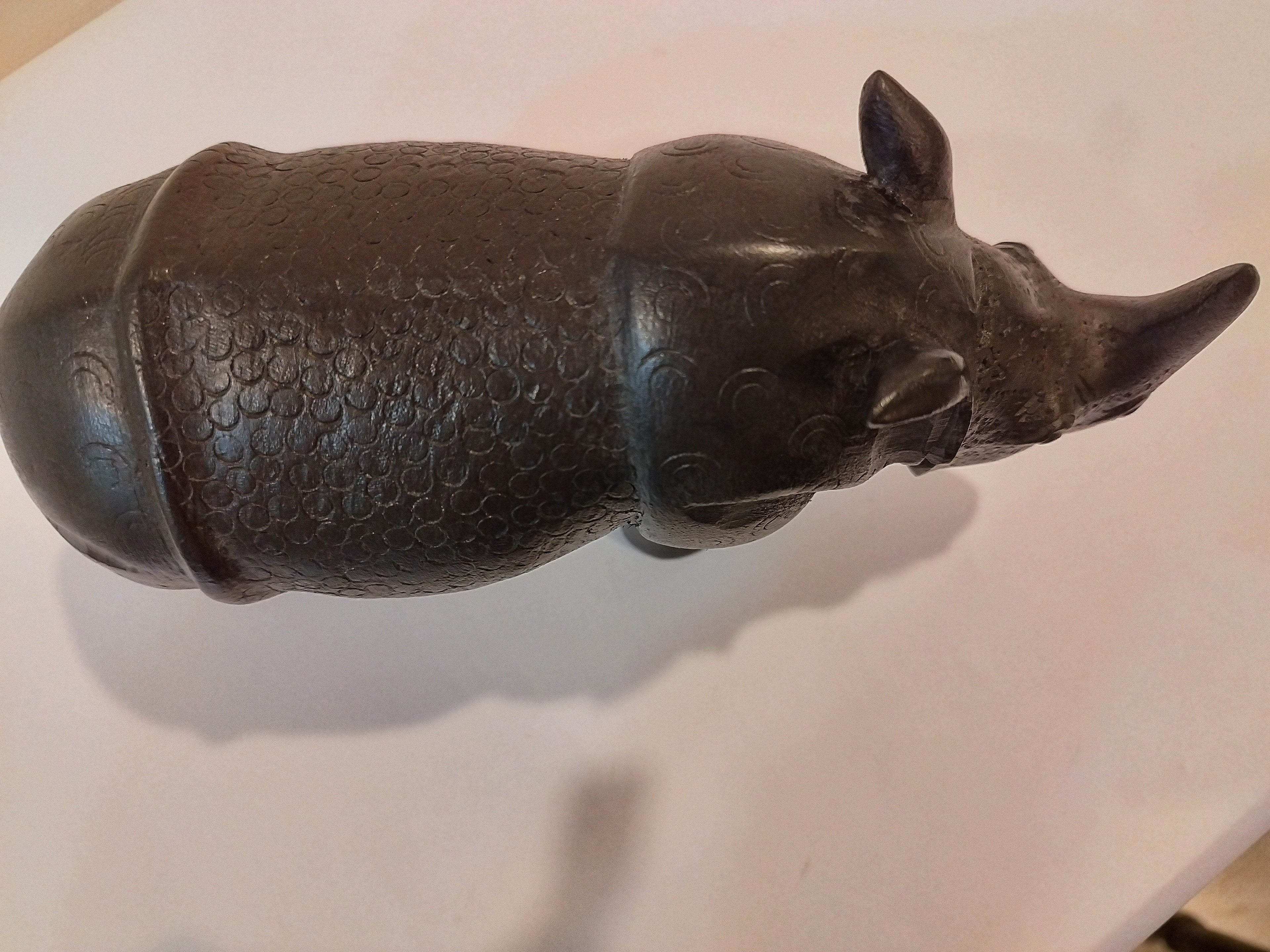 Rhino in black wood, five inches height and nine inch in length. Well known to give strength to a person, family, office.