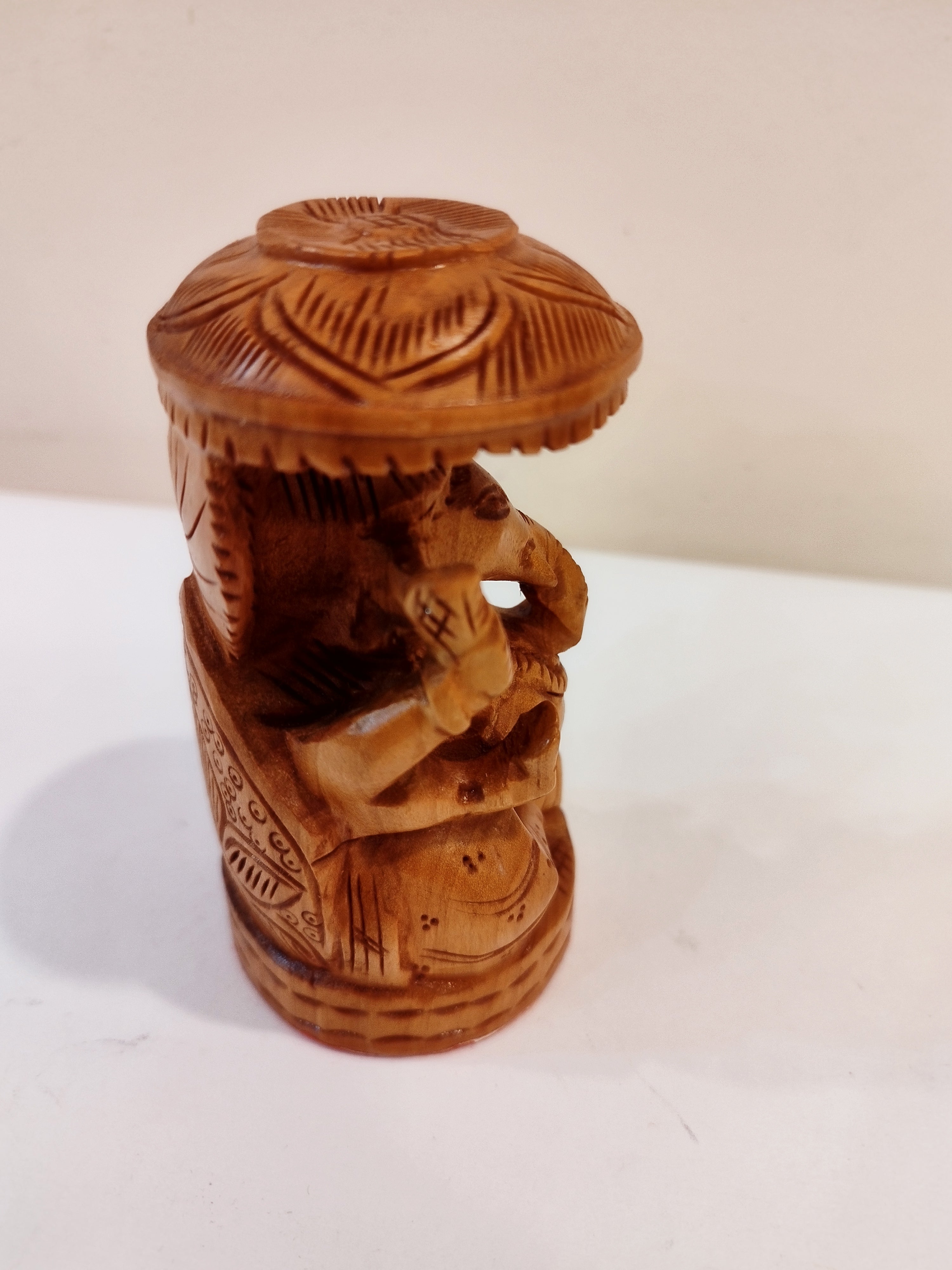 Hindu deity Vinayak, a handcrafted Kadam Wood Ganesha Statue with Chatari