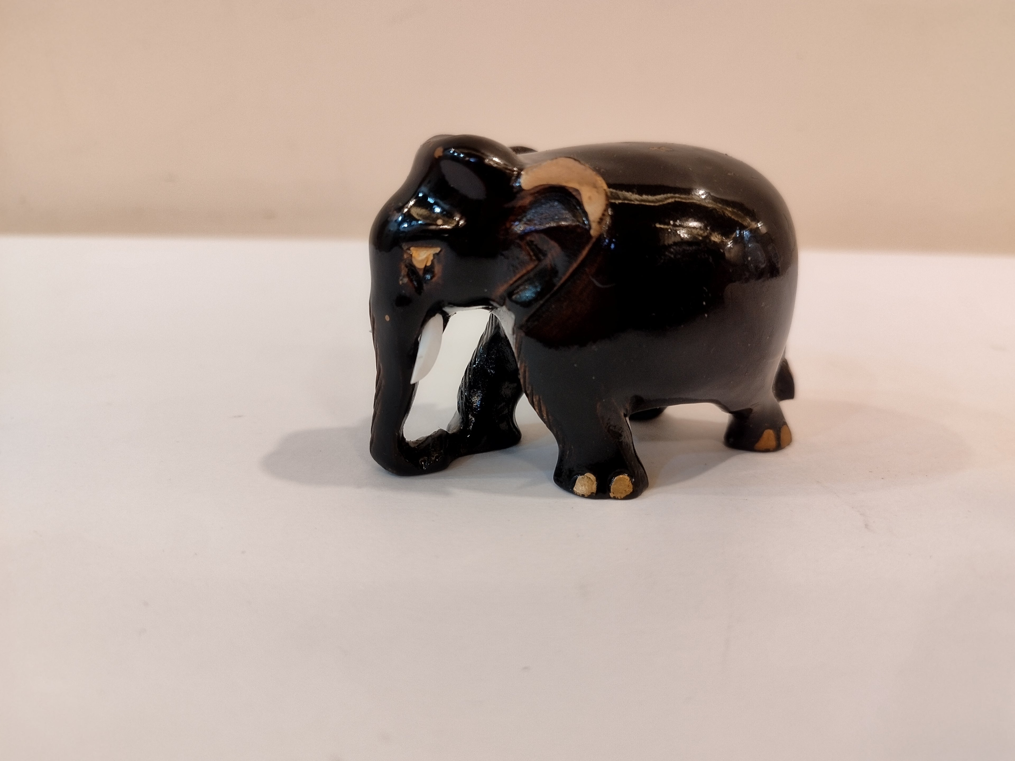 Handcrafted kadam wood black elephant statue  down trunk- 2 inches