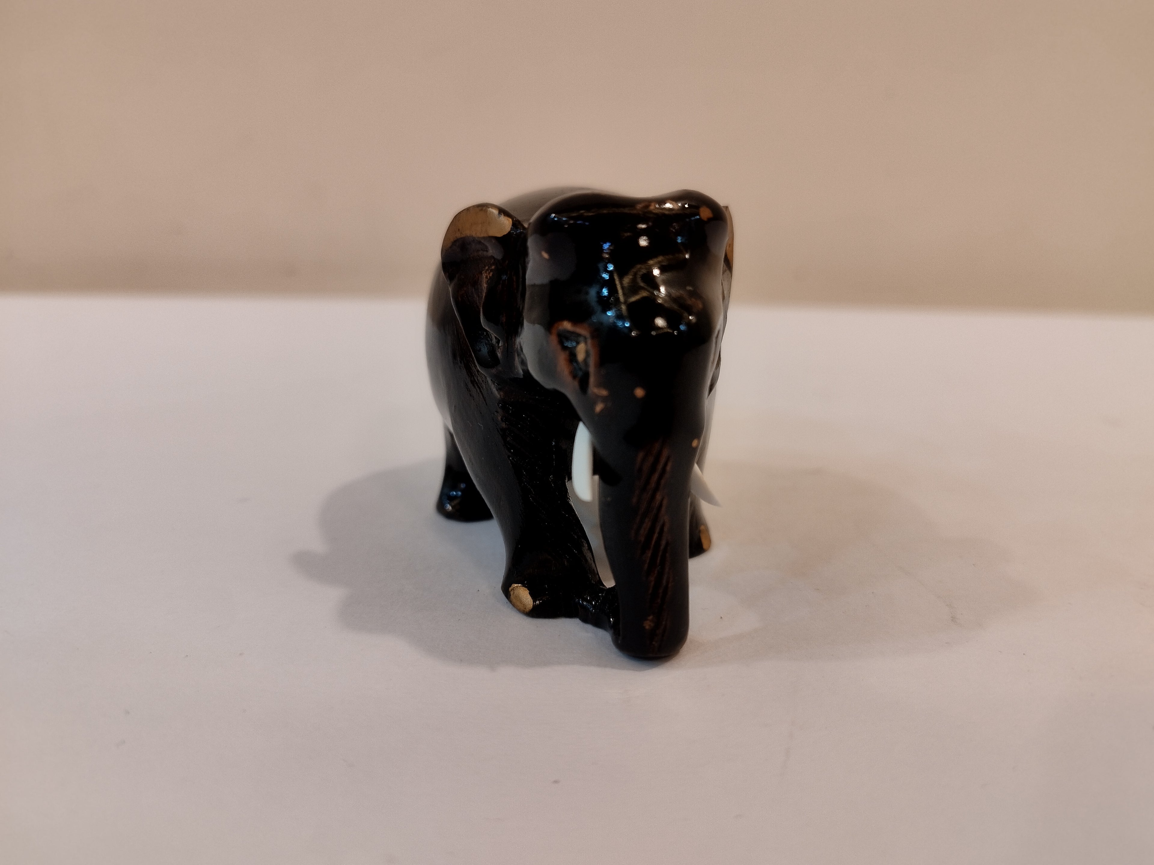 Handcrafted kadam wood black elephant statue  down trunk- 2 inches