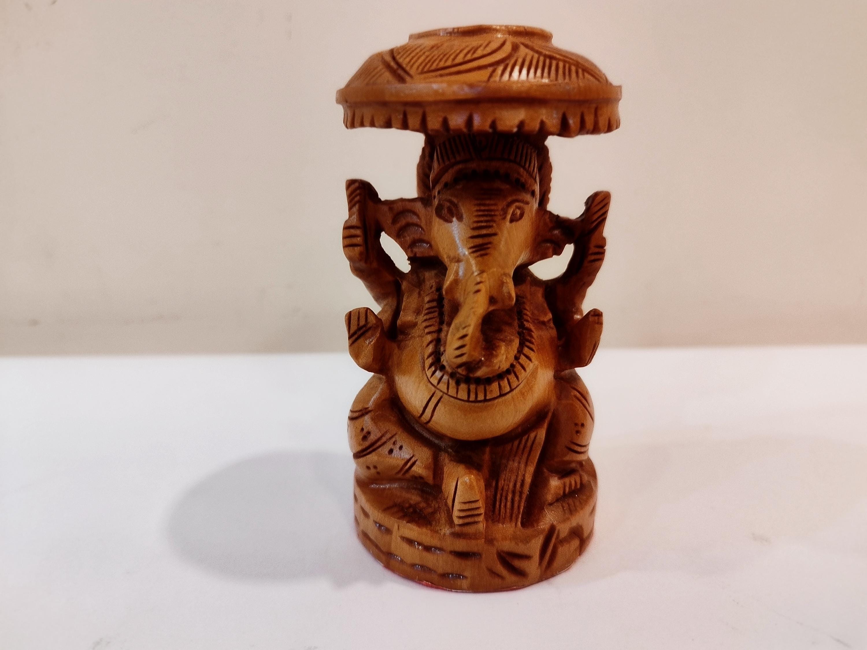 Hindu deity Vinayak, a handcrafted Kadam Wood Ganesha Statue with Chatari