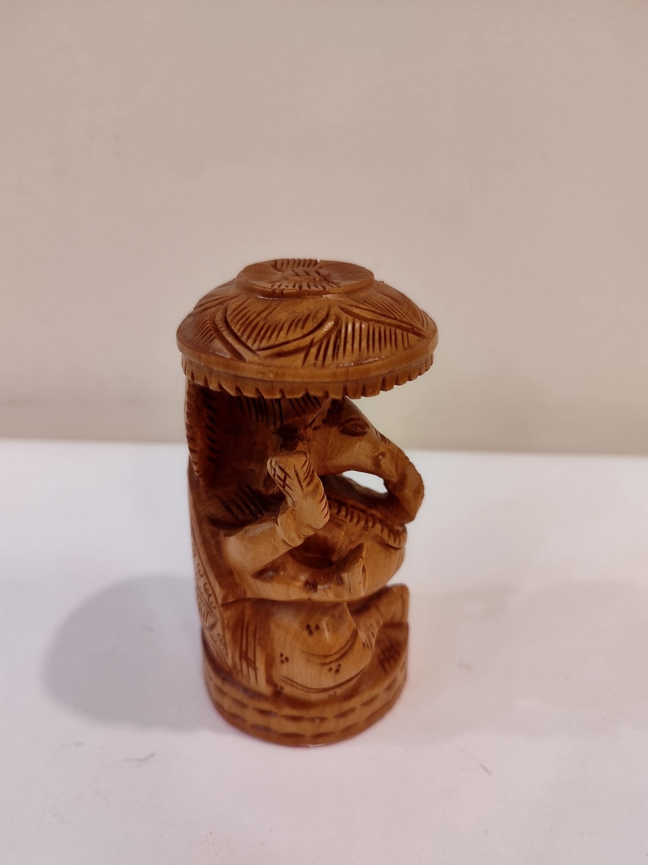 Hindu deity Vinayak, a handcrafted Kadam Wood Ganesha Statue with Chatari