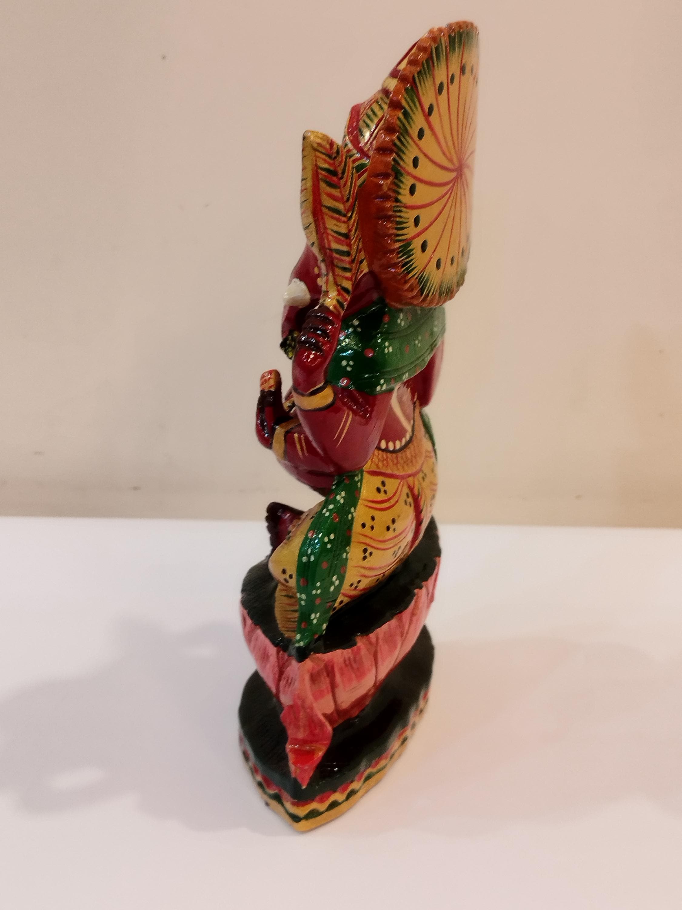 Hindu deity Vinayak, a handcrafted Kadam Wood Painted Ganesha Statue with Chatar (8 inches)