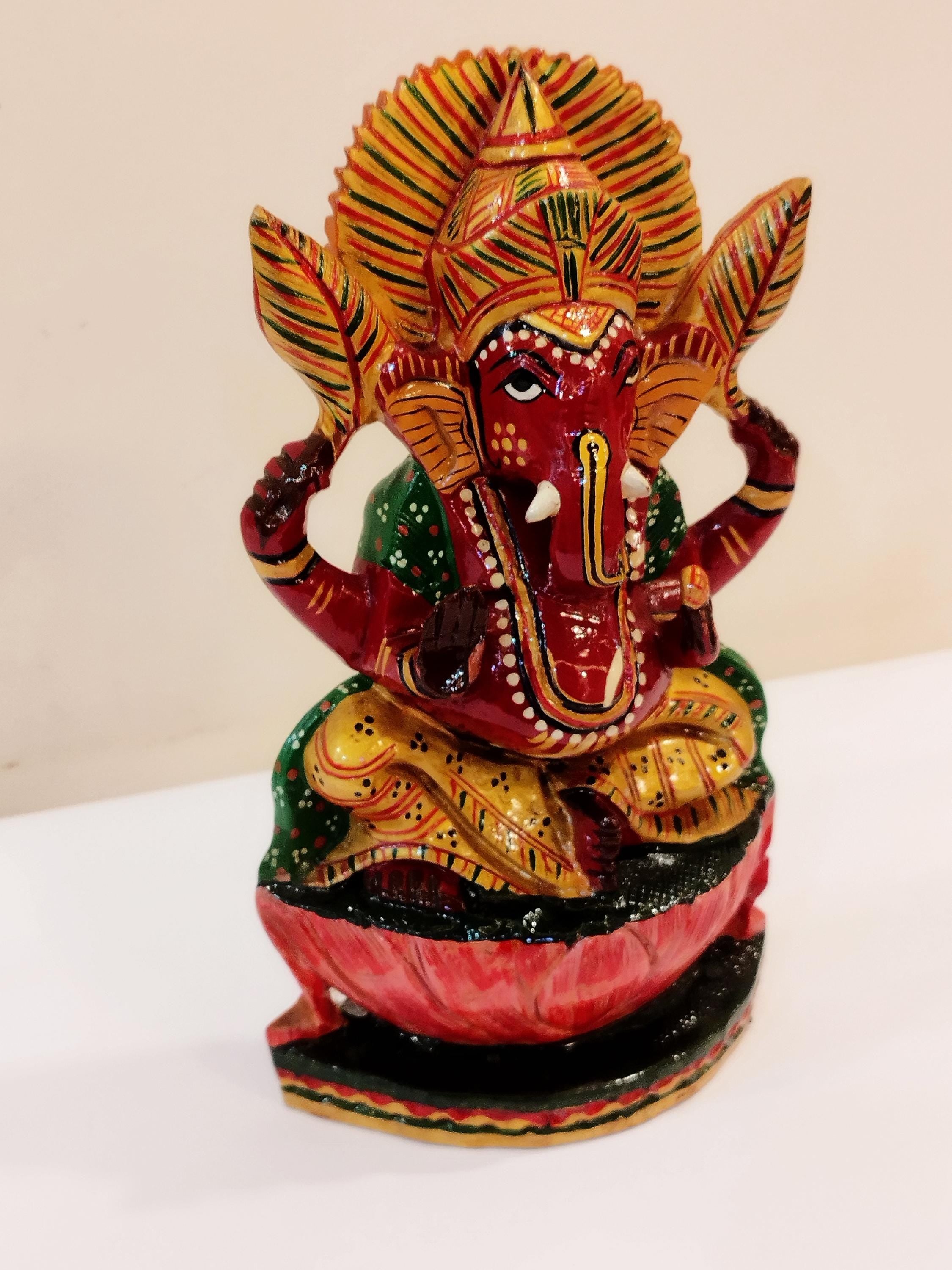 Hindu deity Vinayak, a handcrafted Kadam Wood Painted Ganesha Statue with Chatar (8 inches)