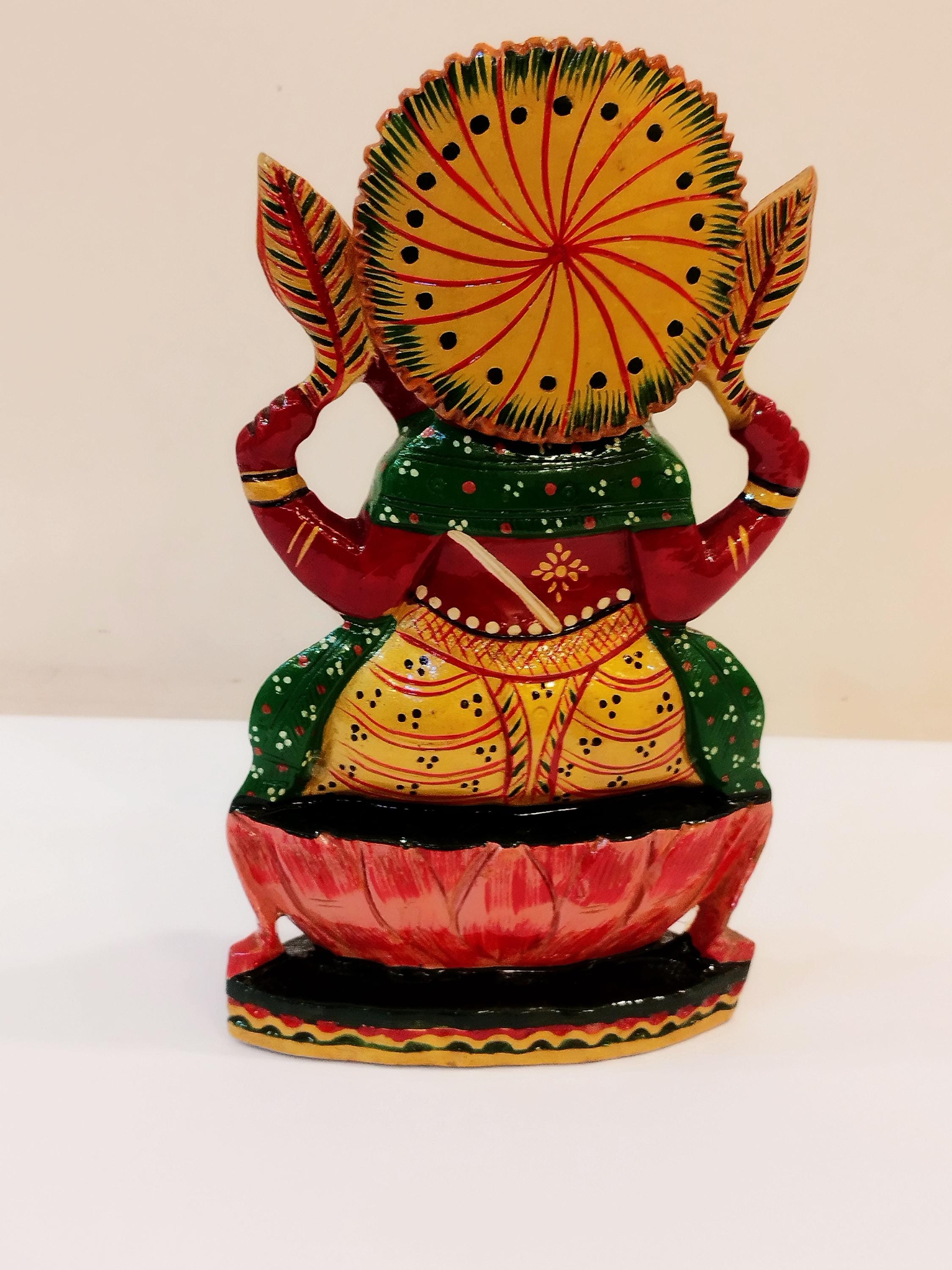 Hindu deity Vinayak, a handcrafted Kadam Wood Painted Ganesha Statue with Chatar (8 inches)