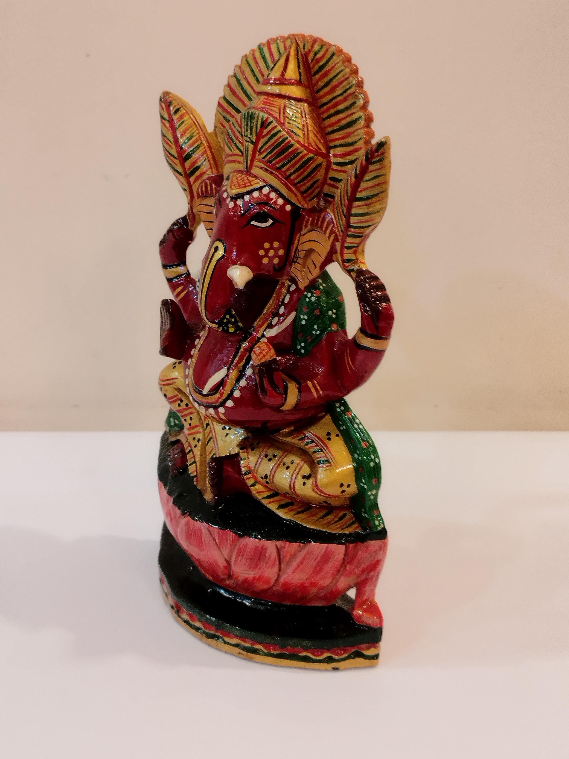 Hindu deity Vinayak, a handcrafted Kadam Wood Painted Ganesha Statue with Chatar (8 inches)