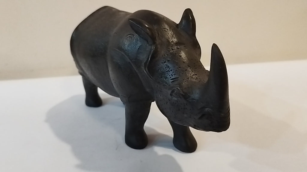 Rhino in black wood, five inches height and nine inch in length. Well known to give strength to a person, family, office.