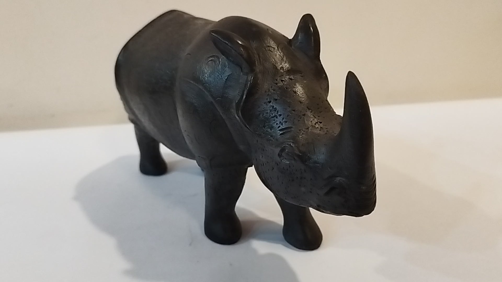 Rhino in black wood, five inches height and nine inch in length. Well known to give strength to a person, family, office.